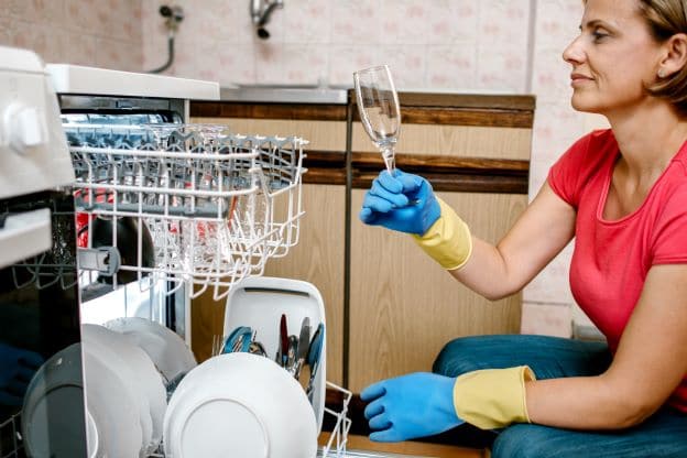 woman unhappy with spotty dishes due to hard water