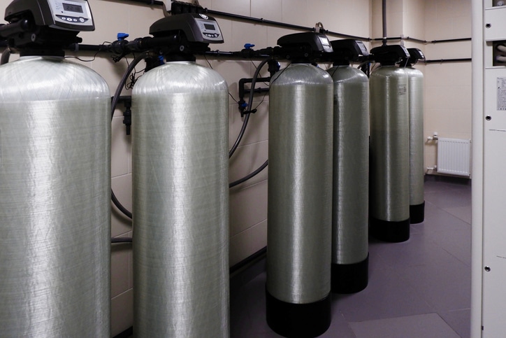 several water softener filters for water stand in a row.water treatment system.ecology